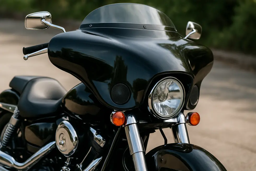 A detailed view of a cruiser motorcycle equipped with a Reckless Batwing fairing emphasizing its aerodynamic shape and built-in functional elements.