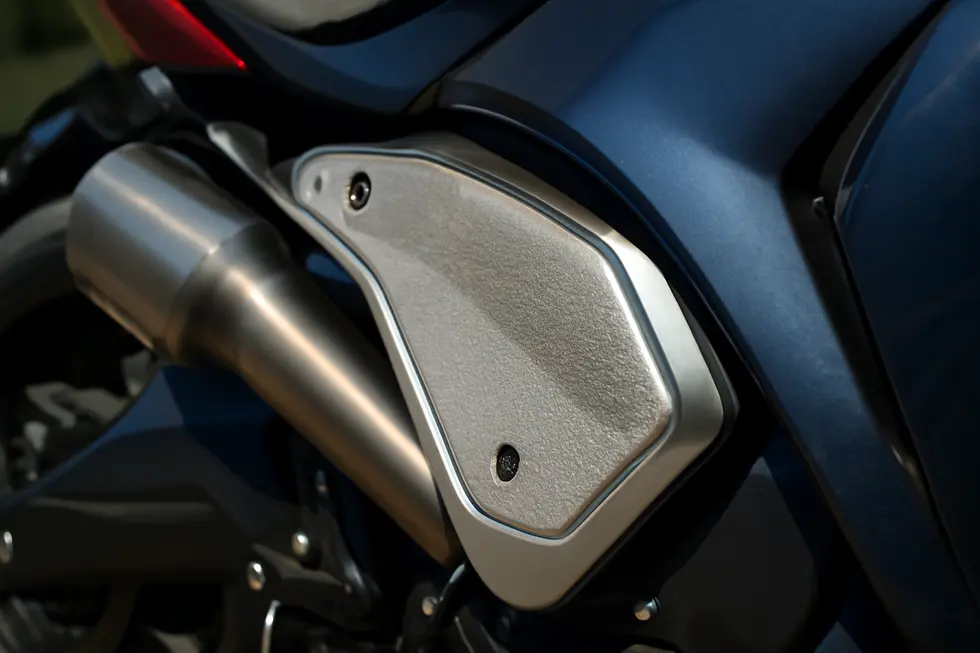 Dual-layer aluminum and insulating materials used in heat shields protect motorcycle fairings from heat damage effectively.