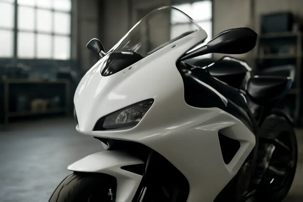 Glossy motorcycle fairing repaired with fiberglass, mounted on sportbike in a clean professional workshop.