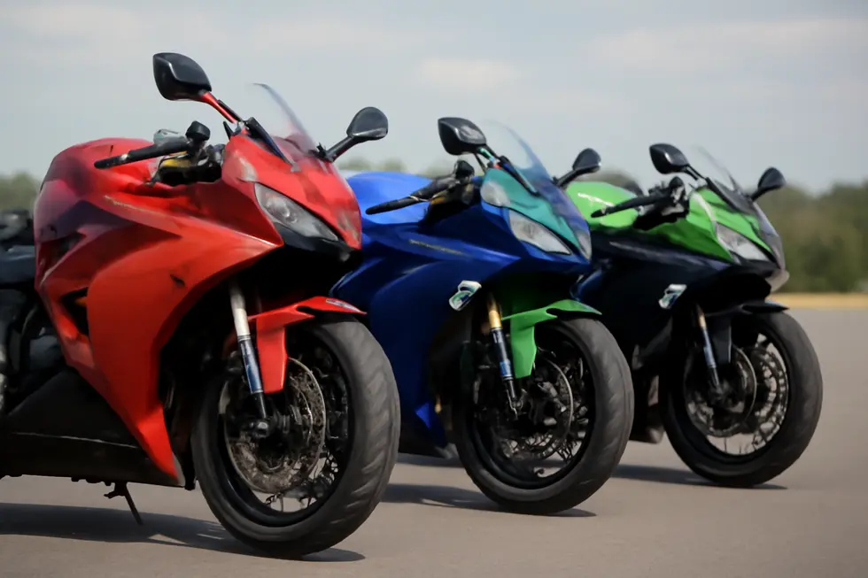 A collection of motorcycles lined up, displaying a variety of side fairings and designs.