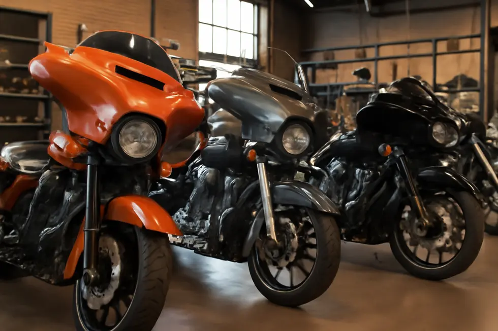 Different motorcycles with touring fairings displayed in a motorcycle shop.